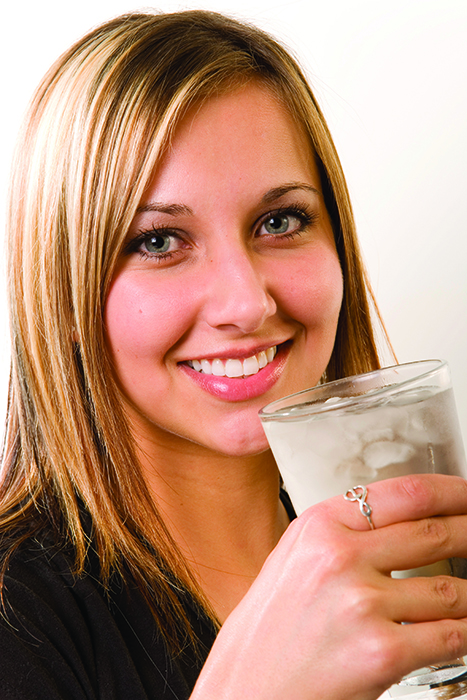 Woman drinking a glass of ice water
