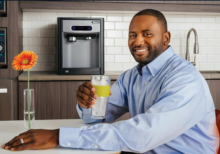man in break room enjoying a glass of water